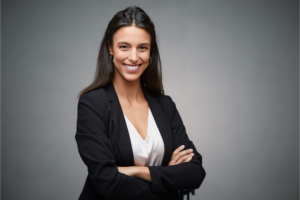 young professional woman smiling and standing with her arms crossed, professional headshot photography, professional headshot photographer, portrait photographer, portrait photography; photography in Fort Carson