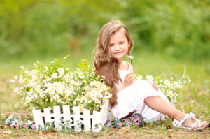 young child sitting outside around baskets of flowers, outdoor photographer, portrait photographer, outdoor photography, portrait photography