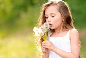 young child outside and blowing on a dandelion, outdoor photographer, portrait photographer, outdoor photography, portrait photography