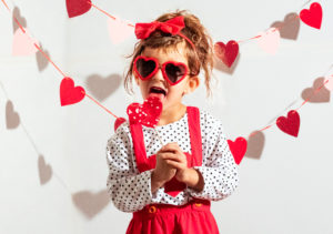 cute child taking valentine photo in a creative way
